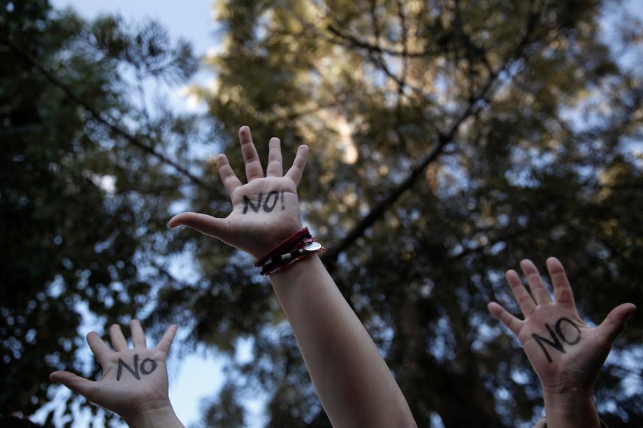 Protesters raise their open palms showing the world "No" during an anti-bailout rally outside the parliament in Nicosia, Cyprus on March 18, 2013.