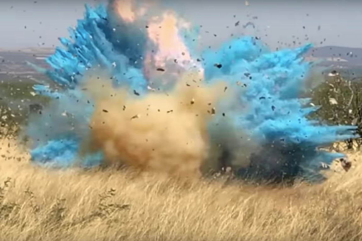 In a still from the video, a viewer can see an explosion of fire and blue in a grasslands setting. 