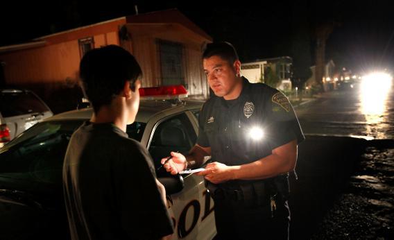 Police Officer Angel Ramirez questions a juvenile victim of an assault in 2010.