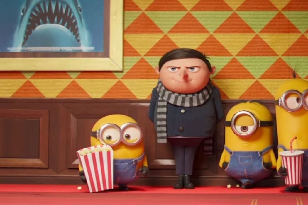 A young Gru from the Despicable Me movies, flanked by three Minions with popcorn and soda.