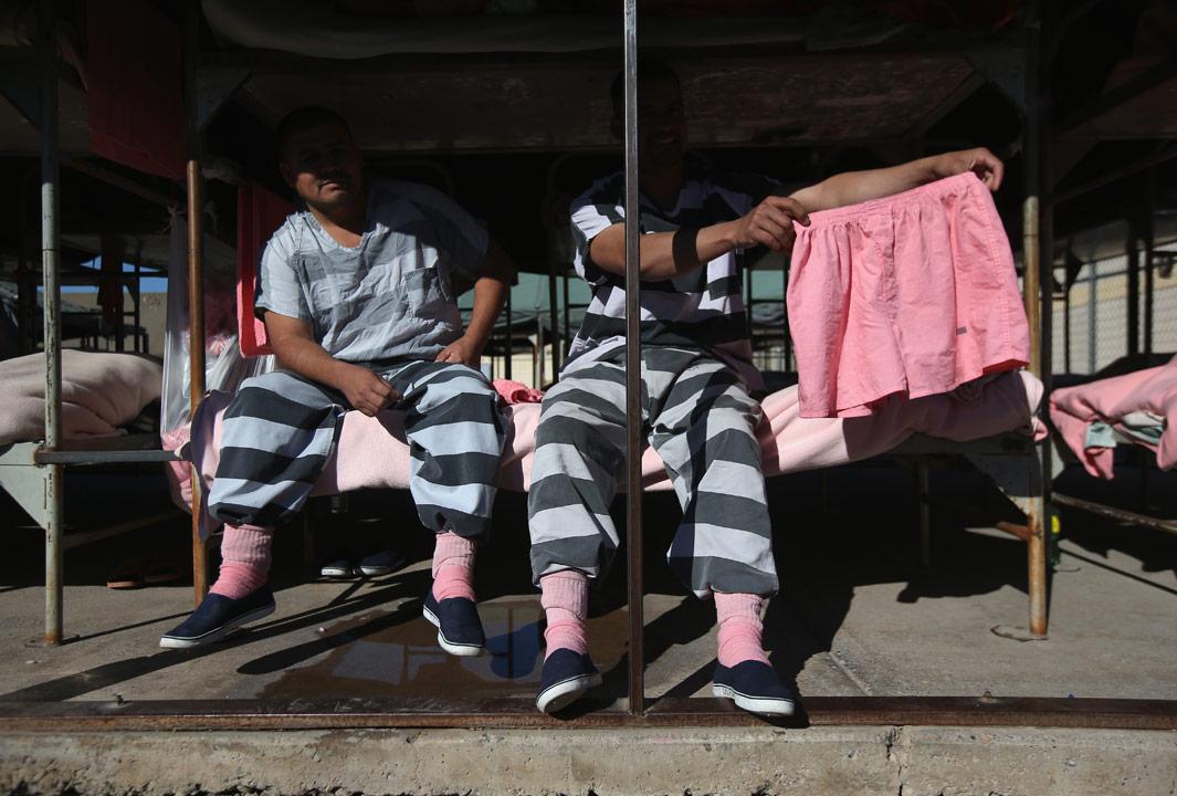 Phoenix, Ariz Immigrant inmates show off a pair of pink underwear while sitting on a bunk in the Maricopa County Tent City jail on March 11, 2013 in Phoenix, Arizona. The striped uniforms and pink undergarments are standard issue at the facility. The tent jail, run by Maricopa County Sheriff Joe Arpaio, houses undocumented immigrants who are serving up to one year after being convicted of crime in the county. Although many of immigrants have lived in the U.S for years, often with families, most will be deported to Mexico after serving their sentences. 