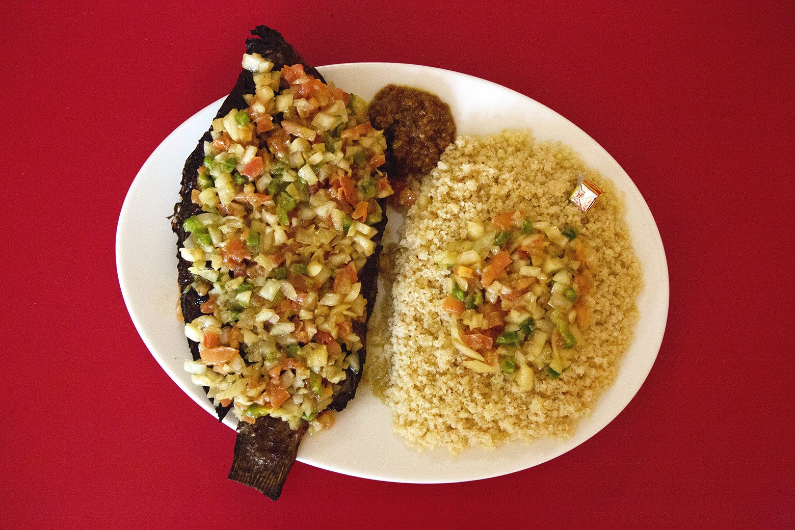 Grilled tilapia and attiéké is served at Le Baobab restaurant.