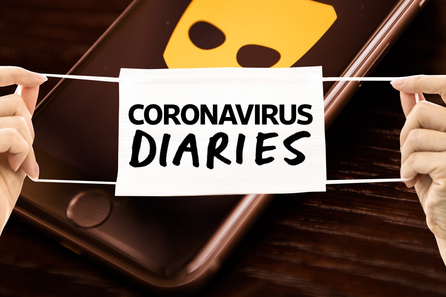A phone with a Grindr logo on it, with a Coronavirus Diaries banner draped across it. 