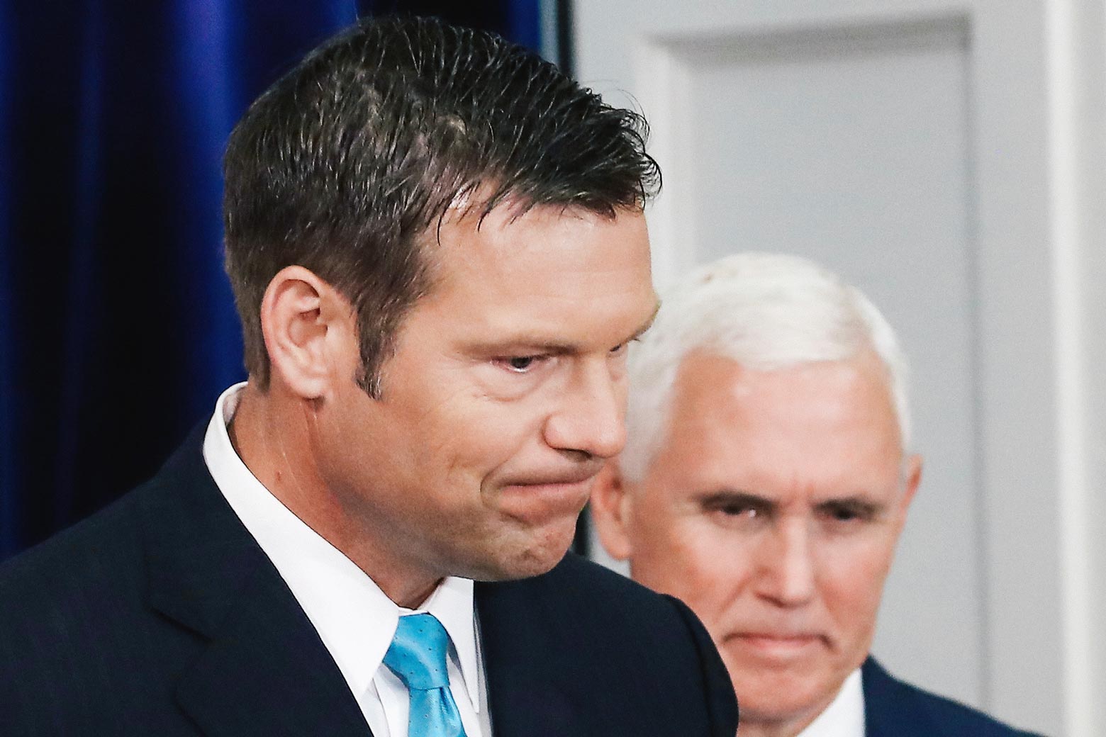 Kansas Secretary of State, Kris Kobach (L) and US Vice President Mike Pence, attend the first meeting of the Presidential Advisory Commission on Election Integrity in the Eisenhower Executive Office Building, on July 19, 2017 in Washington, DC.