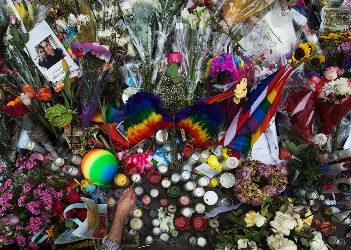 People light candles at a memorial to the Orlando shooting victims outside the Stonewall Inn on June 16, 2016 in New York. 