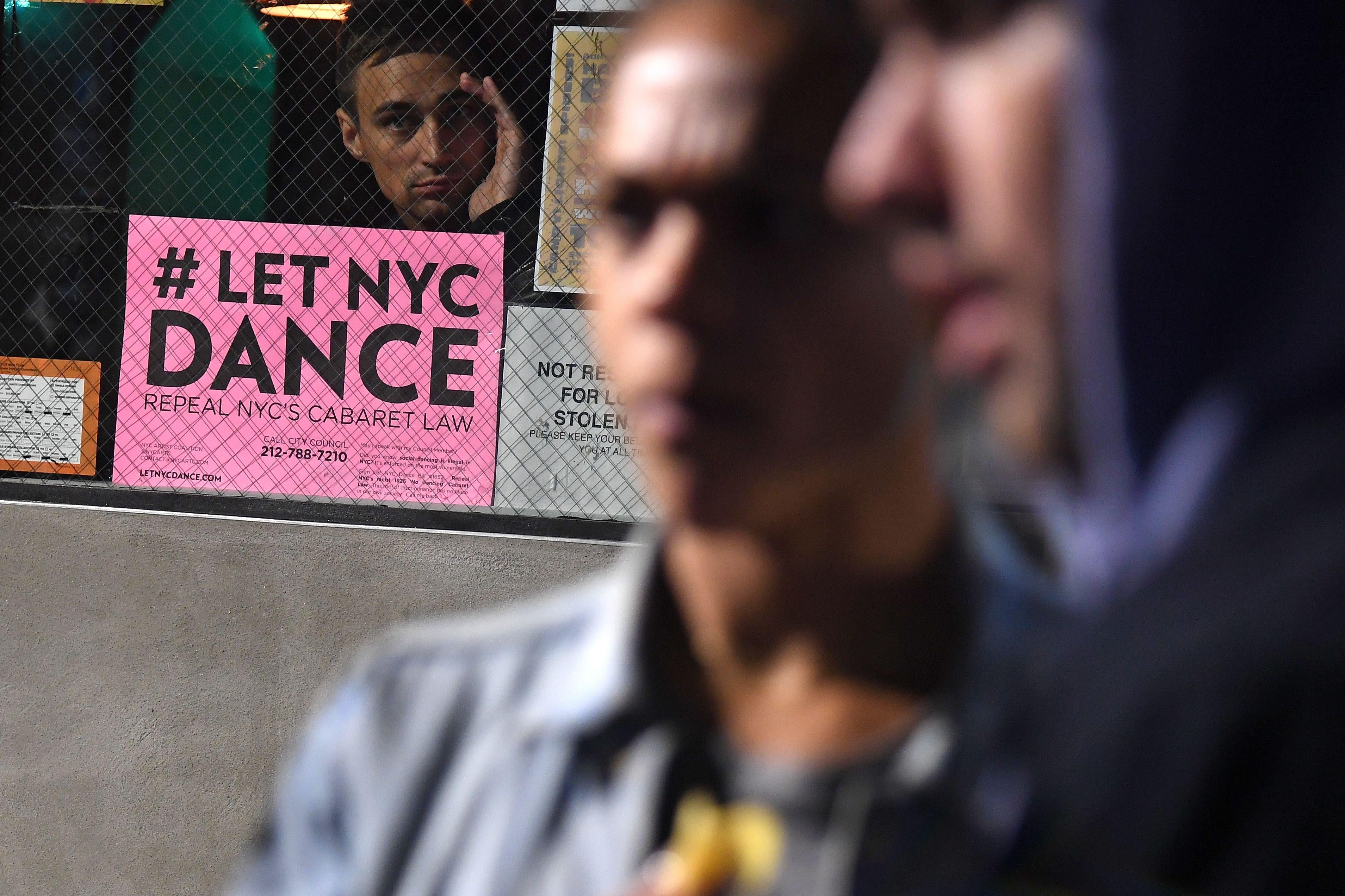 A sign to repeal NYC's Cabaret Law is seen posted at the Brooklyn venue Secret Project Robot.