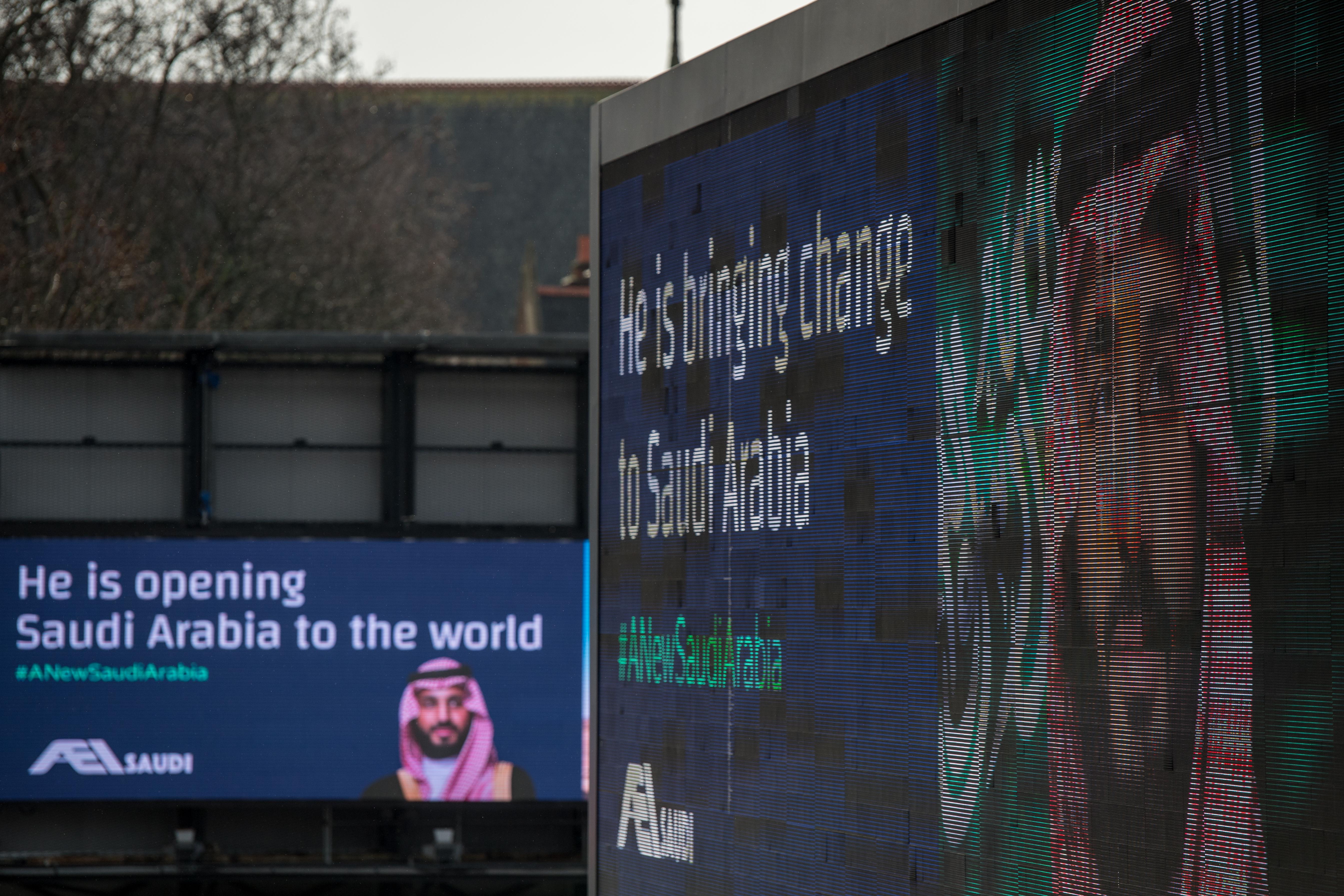 Electronic billboards show adverts for Saudi Crown Prince Mohammed bin Salman with the hashtag '#ANewSaudiArabia' on March 7, 2018 in London, England.