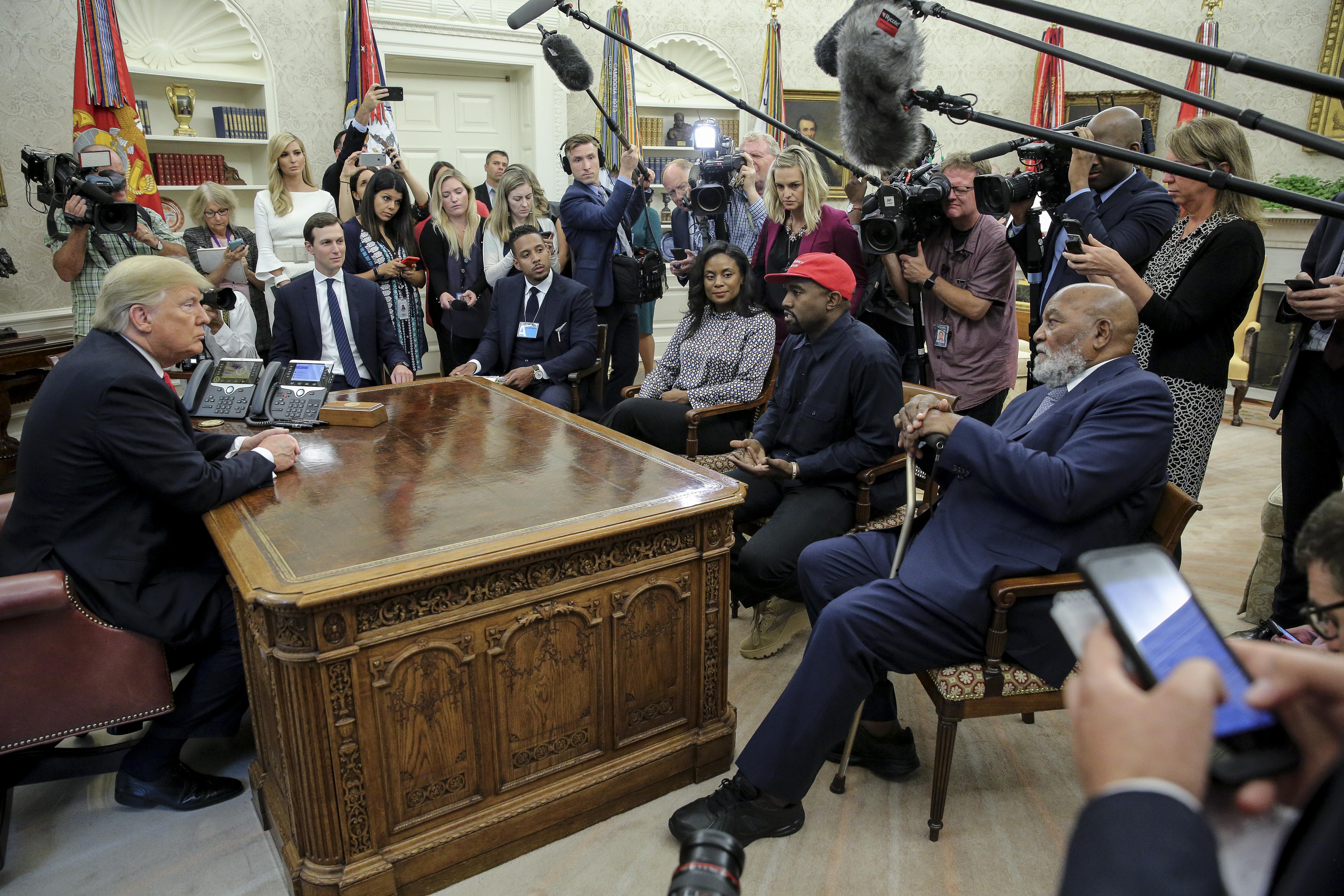 Rapper Kanye West, second right, flanked by NFL Hall of Famer Jim Brown, right, speaks during a meeting with President Donald Trump, left, in the Oval office of the White House on October 11, 2018 in Washington, DC. Next to Trump, Ivanka Trump and Senior Advisor to the President, Jared Kushner.