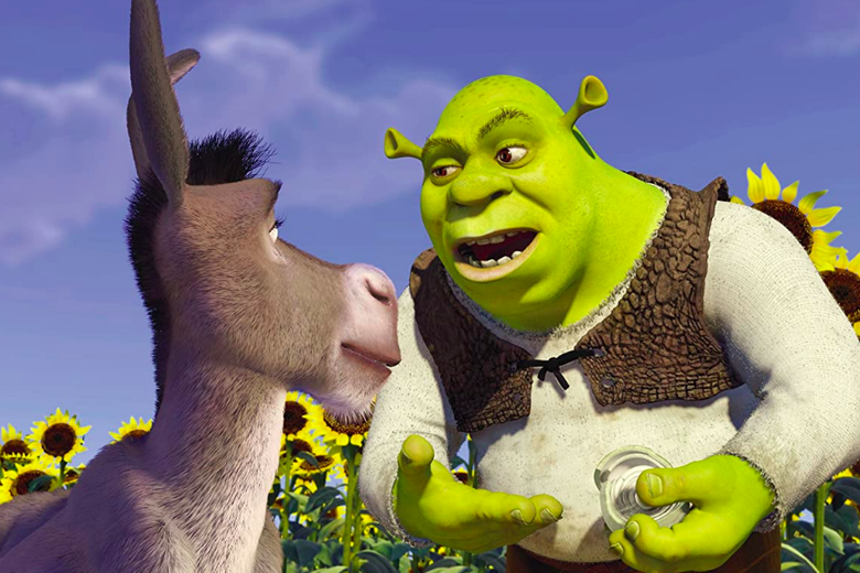 In a field of sunflowers against a bright blue sky, green-skinned Shrek shows Donkey an onion.