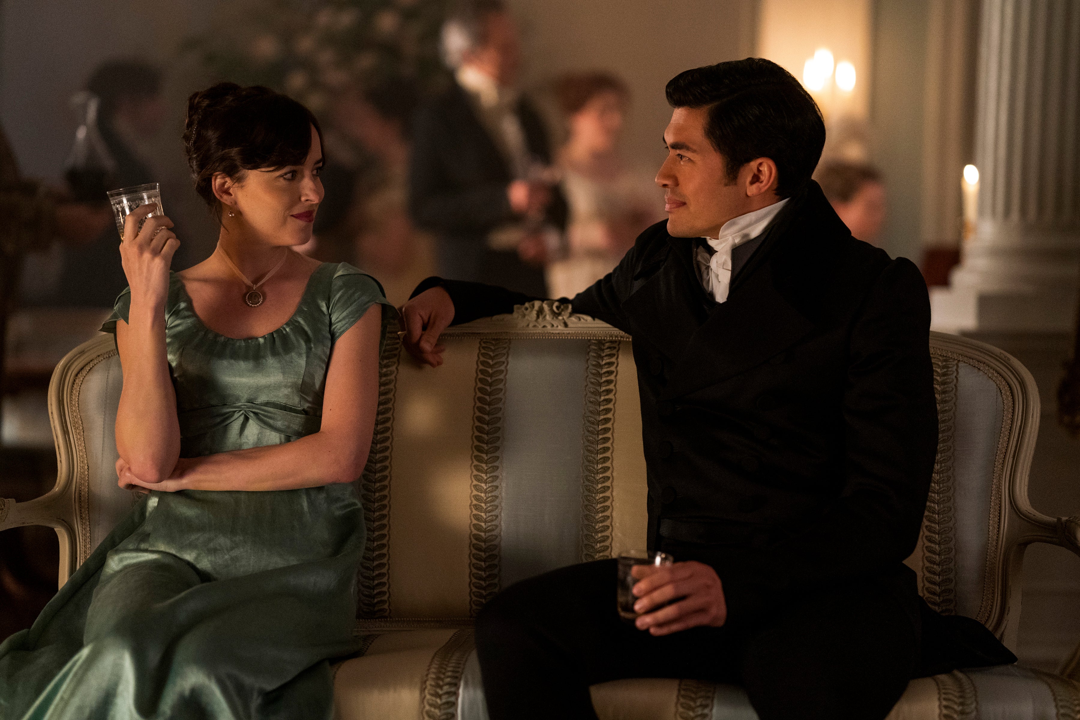 A man and a women in fancy Regency dress stare into each others' eyes.