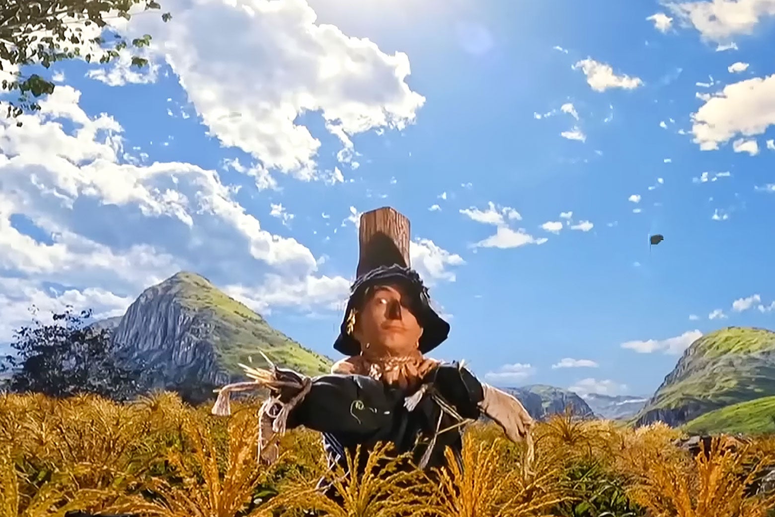 A still looks like The Wizard of Oz but not. The Scarecrow looks normal, but above him is a vast blue sky that looks like a Windows XP background.
