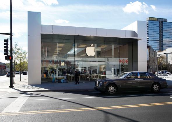 A car drives by an Apple Store in Chicago, Illinois, in 2010. Apple is now rumored to be building a car of its own.