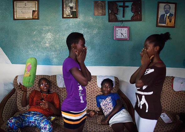 Girls play a clapping game during a weekly education session about breast ironing and rape by survivor of breast ironing Julie Ndjessa at Ndjessa's family home in Douala, Cameroon, November 3, 2013.