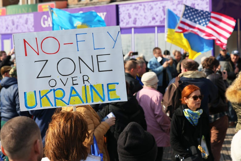 A sign that says "No-Fly Zone Over Ukraine" in a crowd of people at a pro-Ukraine rally on the Brighton Beach Boardwalk