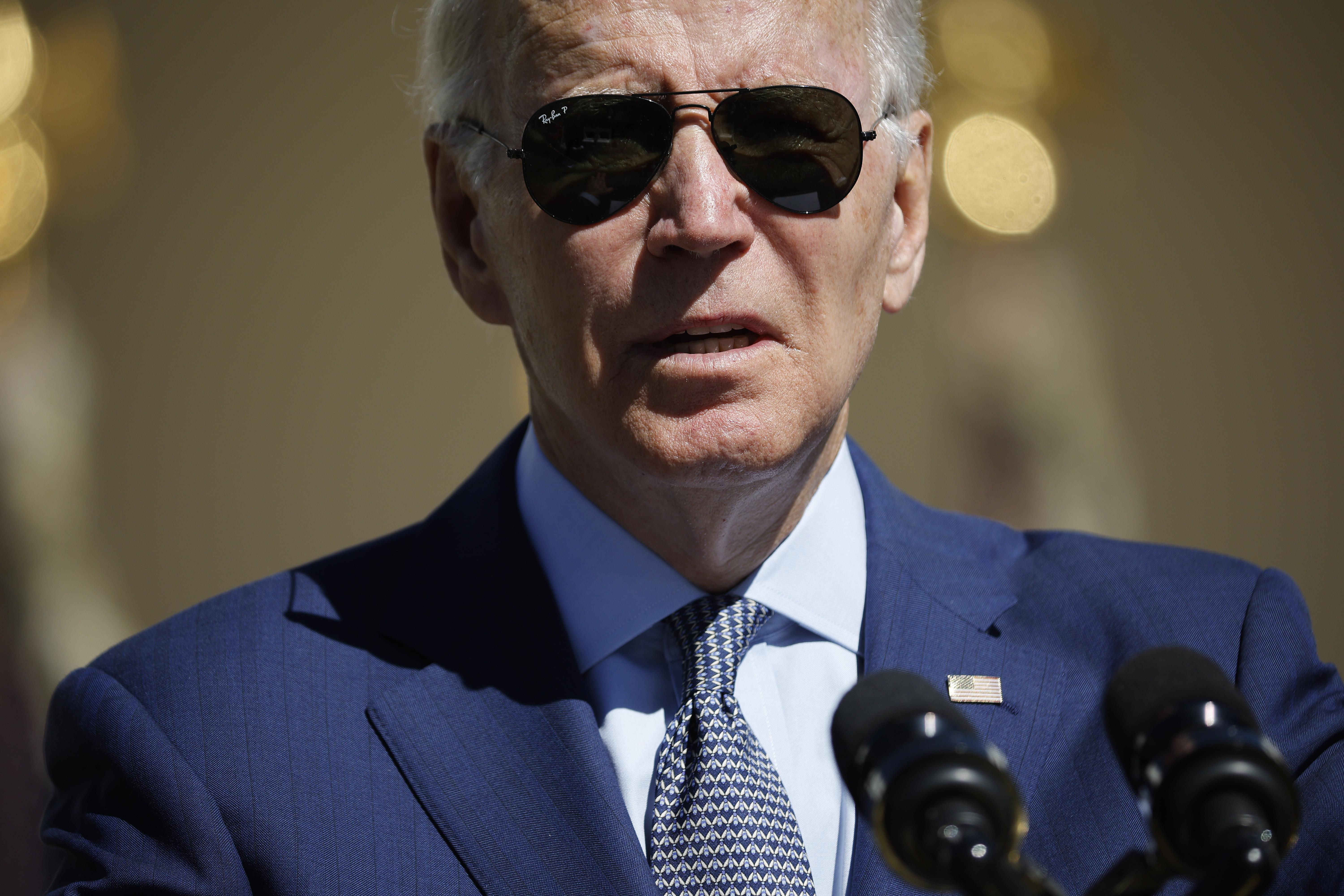Biden wearing aviator sunglasses and a suit.