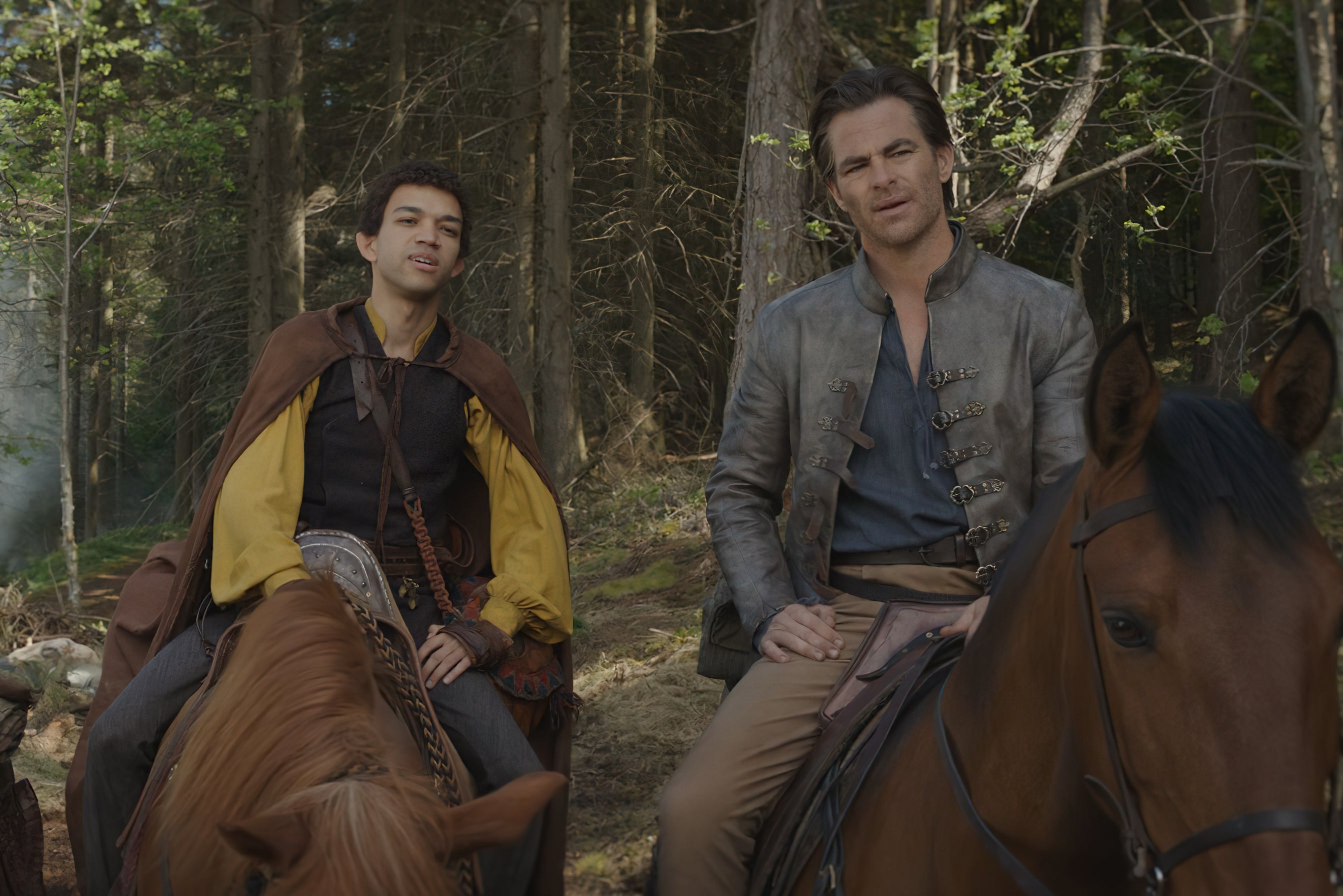The two handsome men sit astride their noble steeds, puzzled looks on their faces