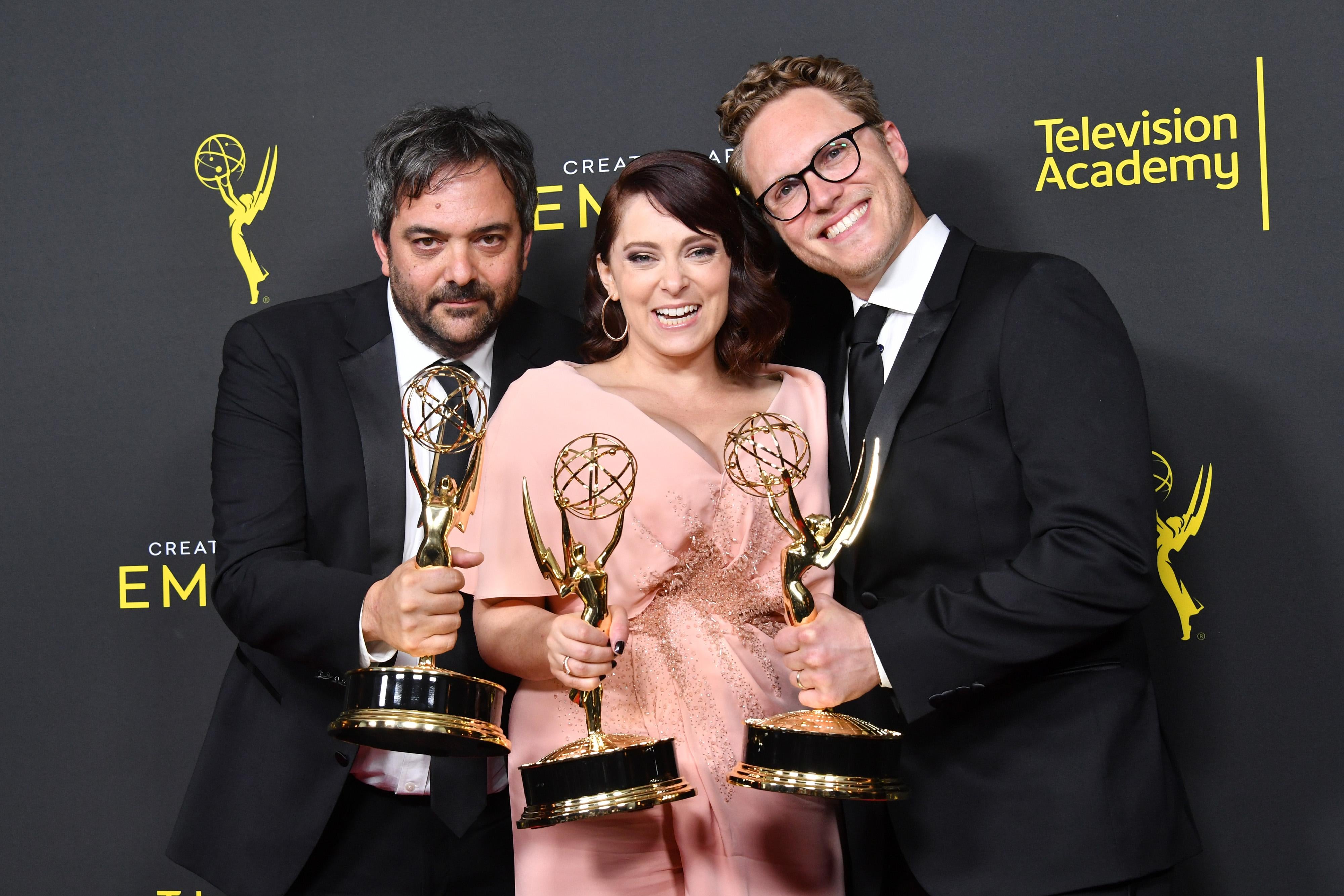 Adam Schlesinger, Rachel Bloom, and Jack Dolgen hold Emmy statuettes.
