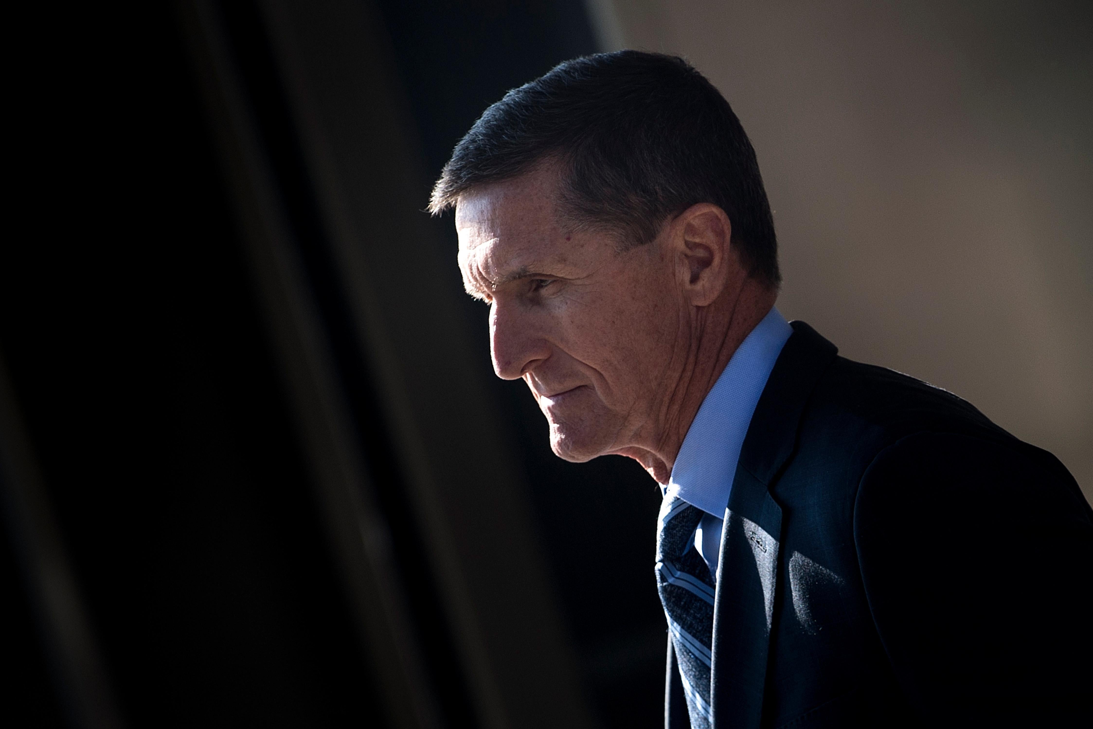 A close-up of Flynn walking away with a blank expression on his face.