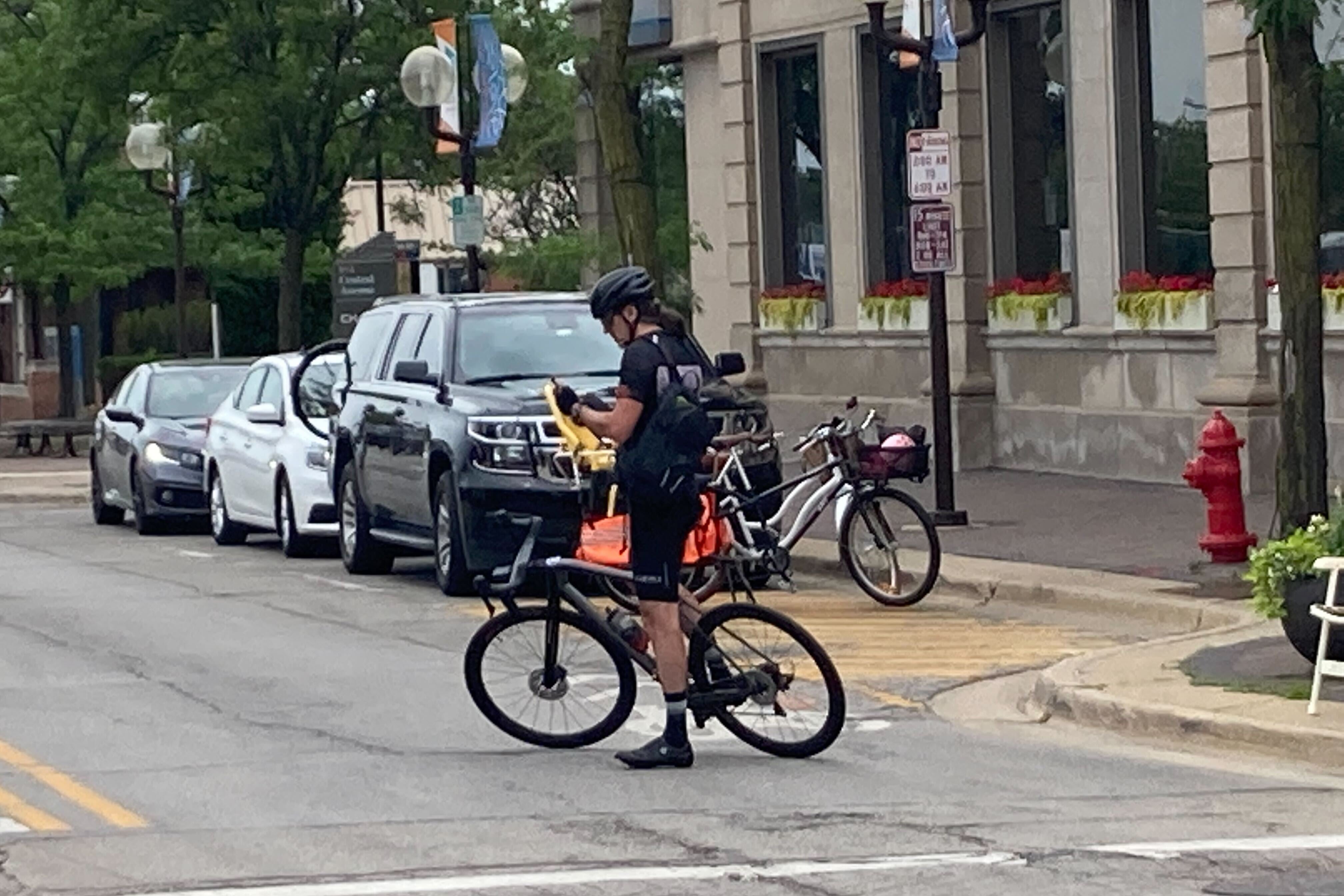 A cyclist pauses in the otherwise abandoned streets.