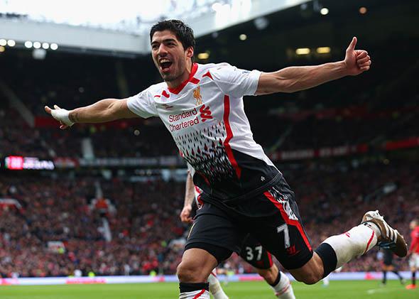 Luis Suarez of Liverpool celebrates scoring his team's third goal.