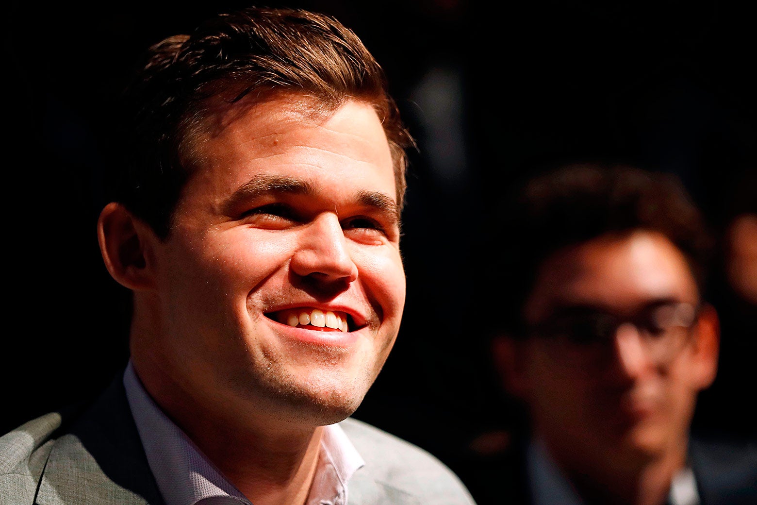 Magnus Carlsen smiles during a press conference after his victory over Fabiano Caruana.