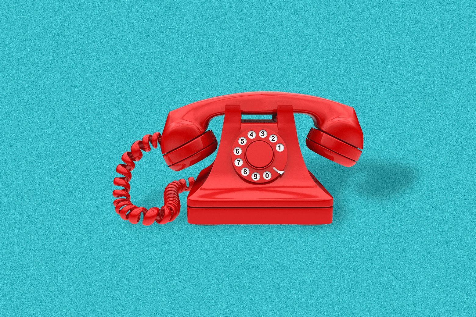 An old-fashioned red phone ringing on the hook.