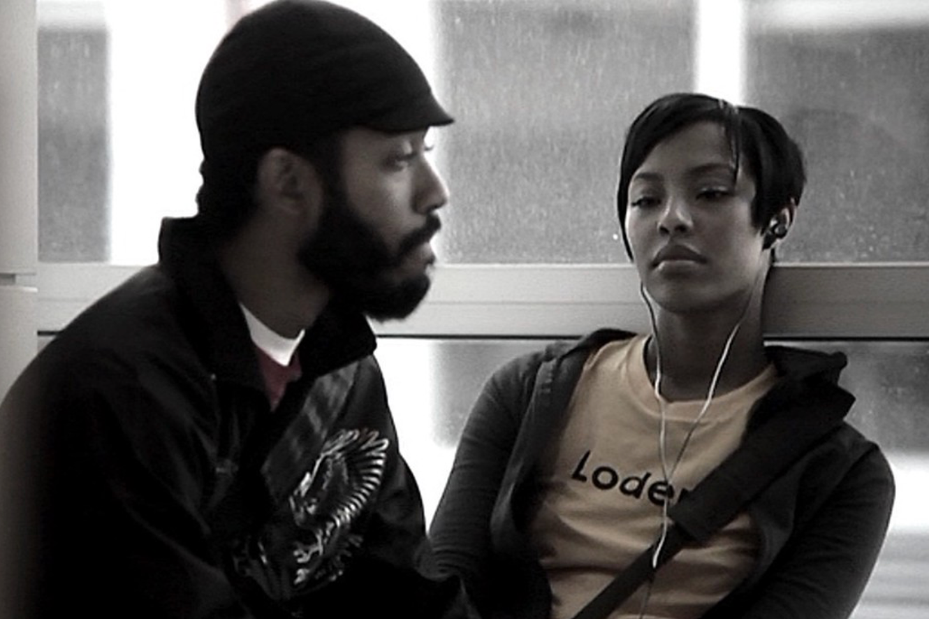 A man and a woman speak to each other in a black and white still from Medicine for Melancholy.