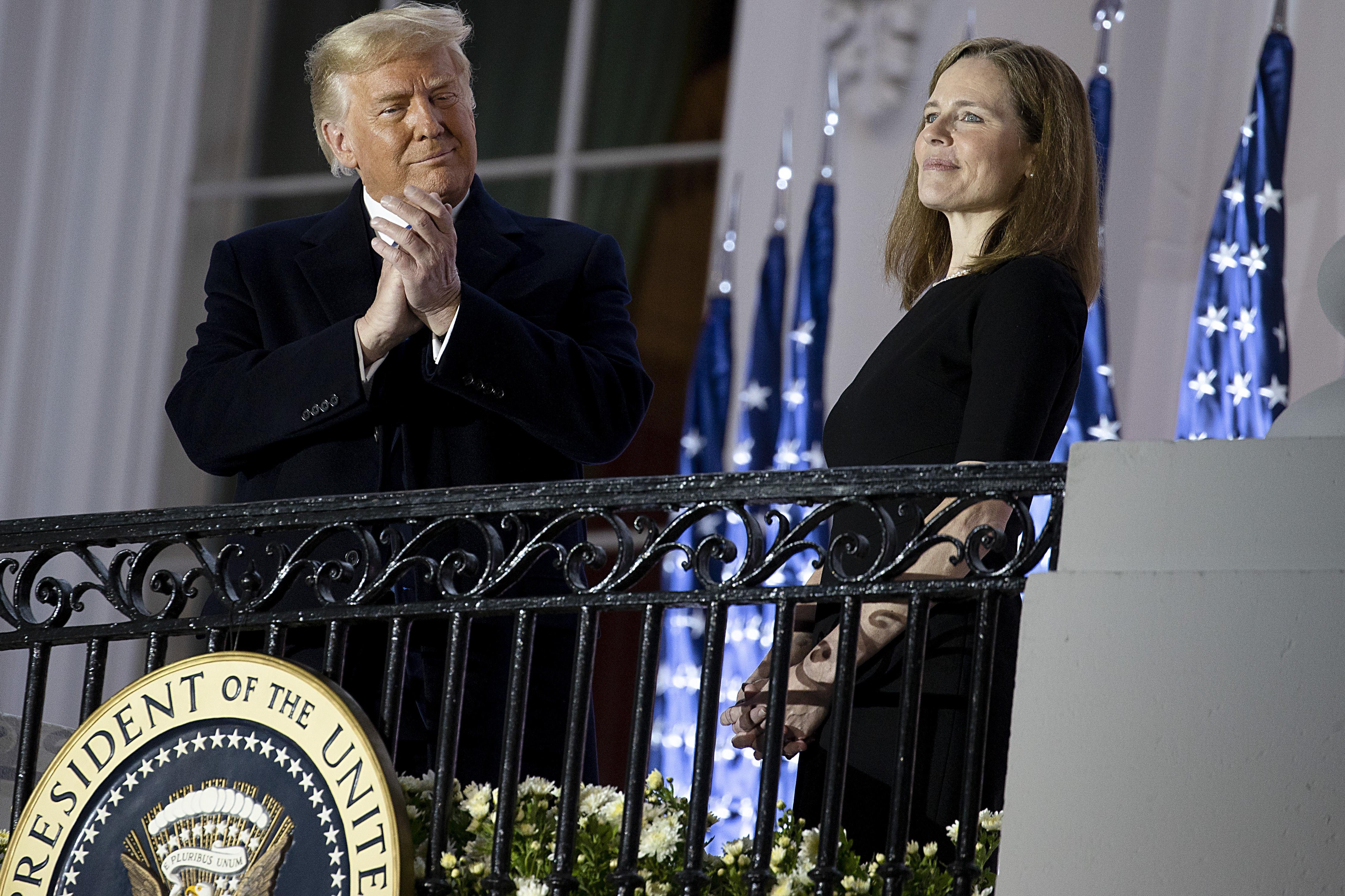 President Donald Trump stands with newly sworn in Supreme Court Associate Justice Amy Coney Barrett during a ceremonial swearing-in event on the South Lawn of the White House October 26, 2020 in Washington, D.C.