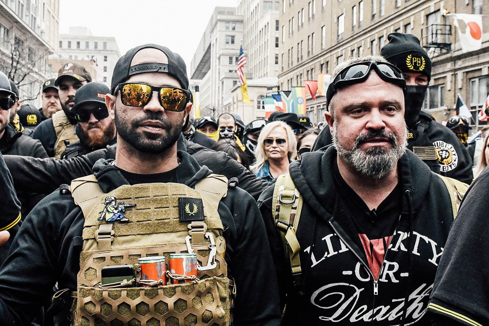 The two men march in a crowd in a downtown street