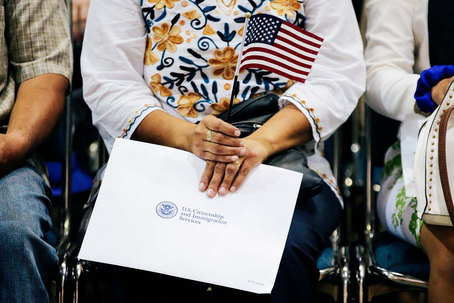 An attendee holds her flag and her naturalization papers as she is sworn in during a U.S. citizenship ceremony in Los Angeles on July 18.