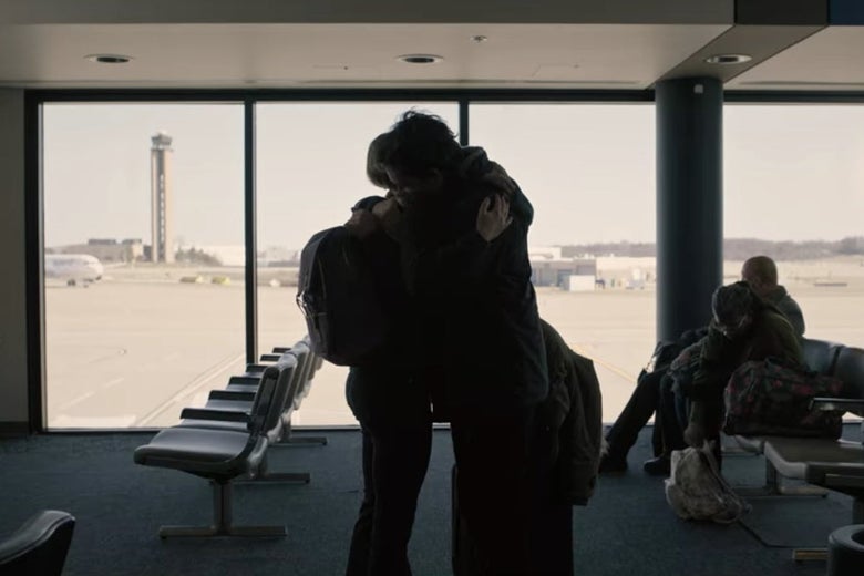 Bill and his daughter hugging in an airport.