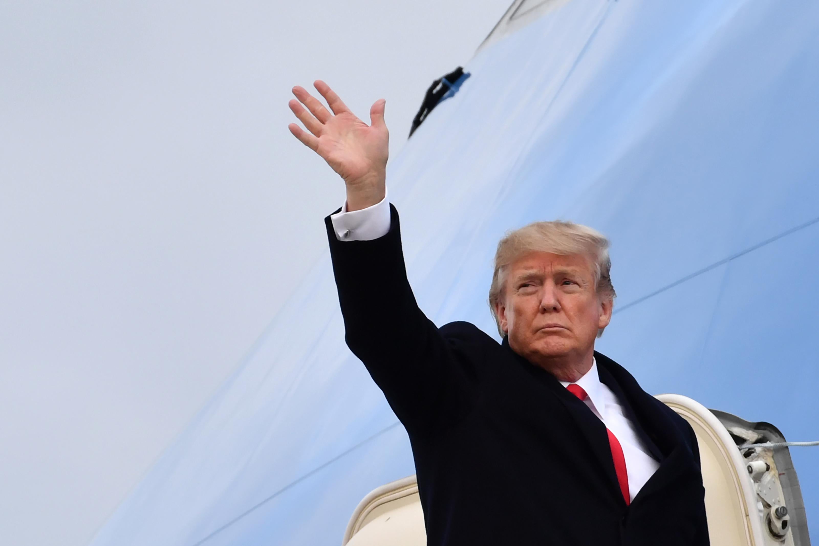 US President Donald Trump waves before boarding the Air Force One ahead of his departure from Zurich Airport in Zurich on January 26, 2018, after attending the World Economic Forum (WEF) annual meeting in Davos. / AFP PHOTO / Nicholas Kamm        (Photo credit should read NICHOLAS KAMM/AFP/Getty Images)