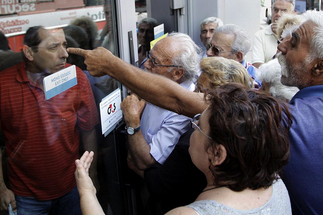 Pensioners waiting outside a closed National Bank branch and hop