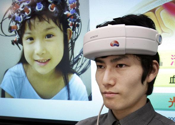 Japanese electronics giant Hitachi unveils a prototype model of a portable brain-machine interface at the company's headquarters in Tokyo, May 2007. 