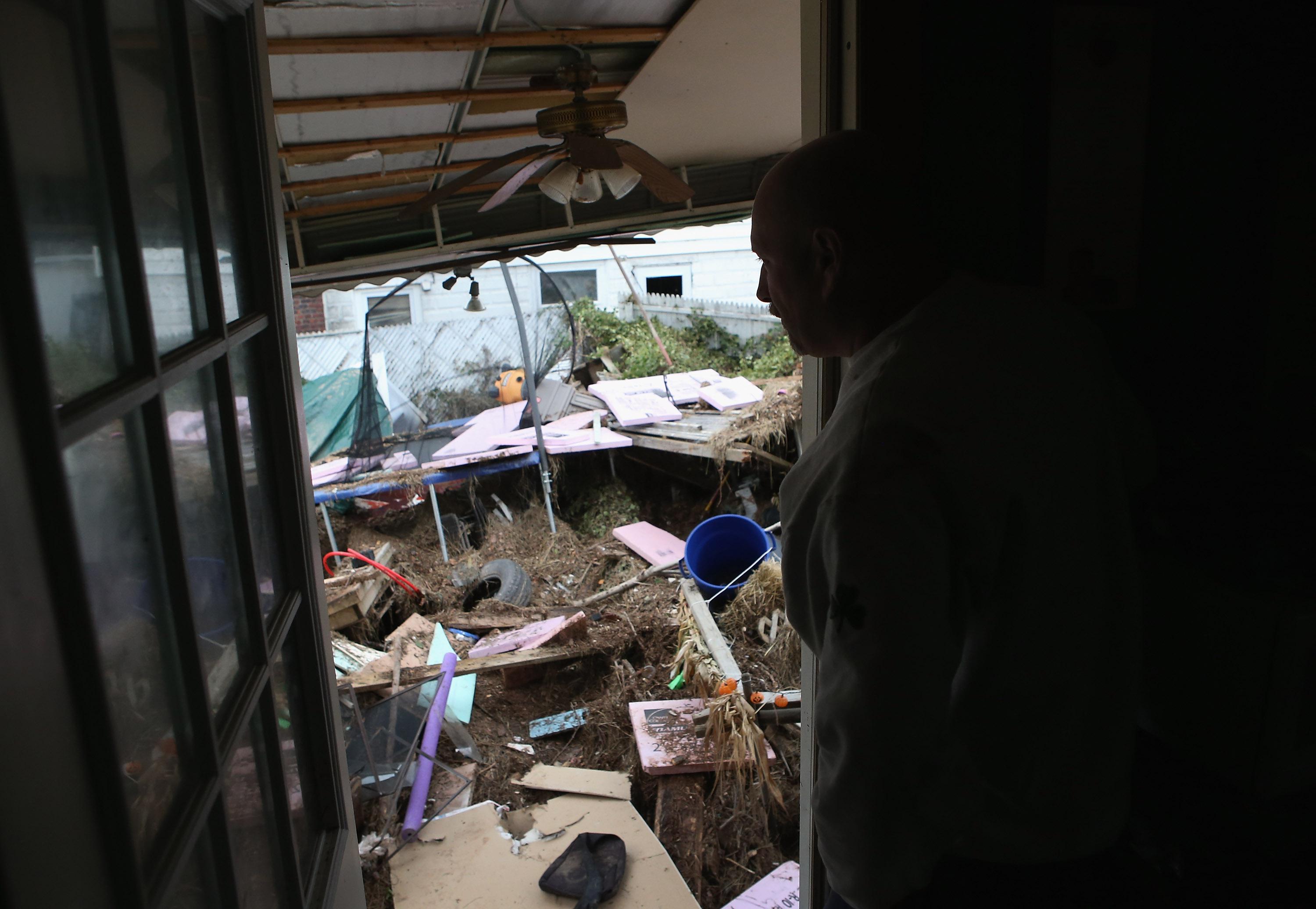 Ronald Forster looks from the back door of his flood-damaged home on November 1, 2012 in the Ocean Breeze area of the Staten Island borough of New York City. 