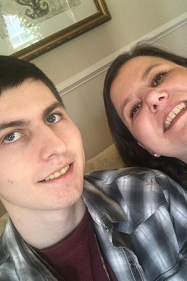 A selfie of a young man and his mother.