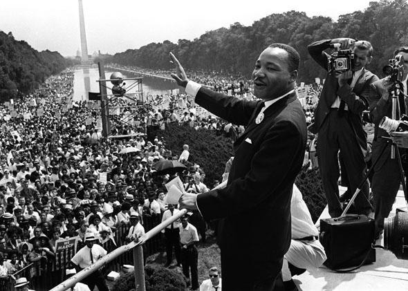 Martin Luther King (C) waves to supporters on the Mall in Washington DC during the "March on Washington", August 1963. 