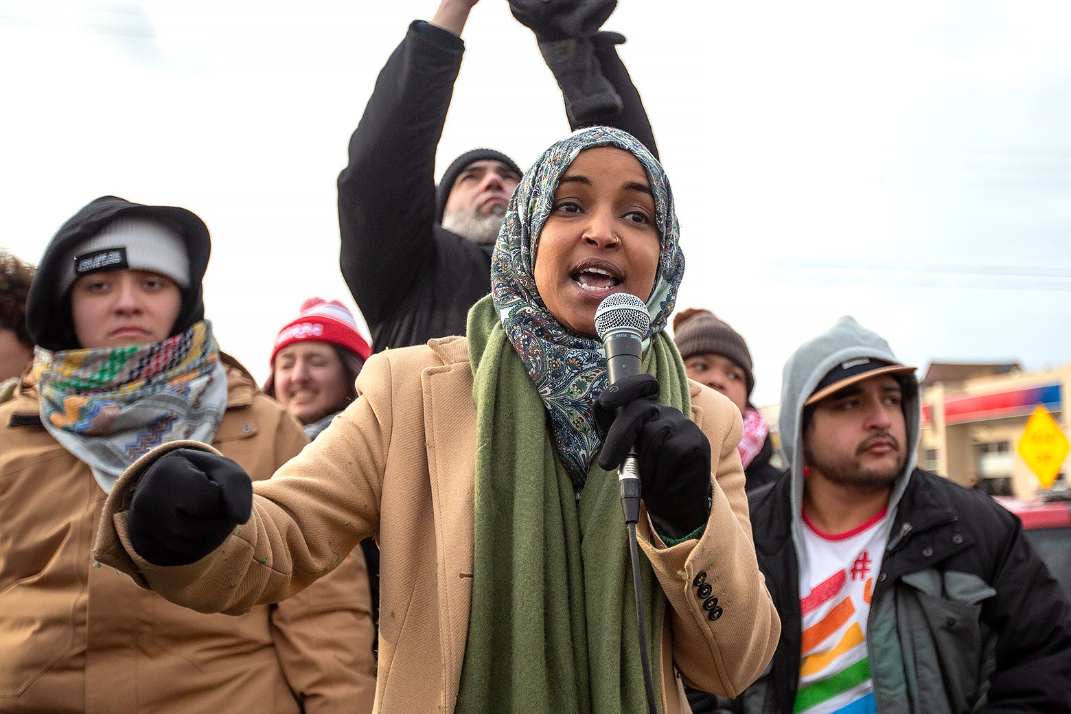Representative Ilham Omar (D-Minn.) speaks into a microphone at a demonstration.
