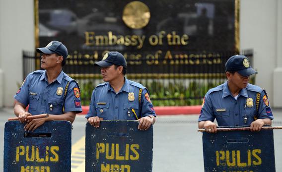 Philippine policemen stand guard in front of the US embassy in Manila.