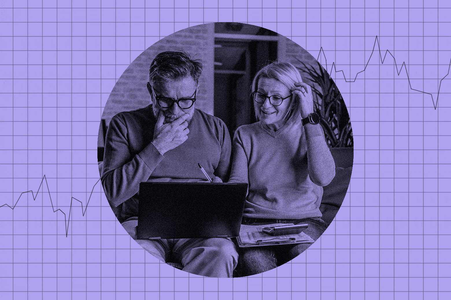 A couple in their 50s sitting on the couch looking at a laptop together.