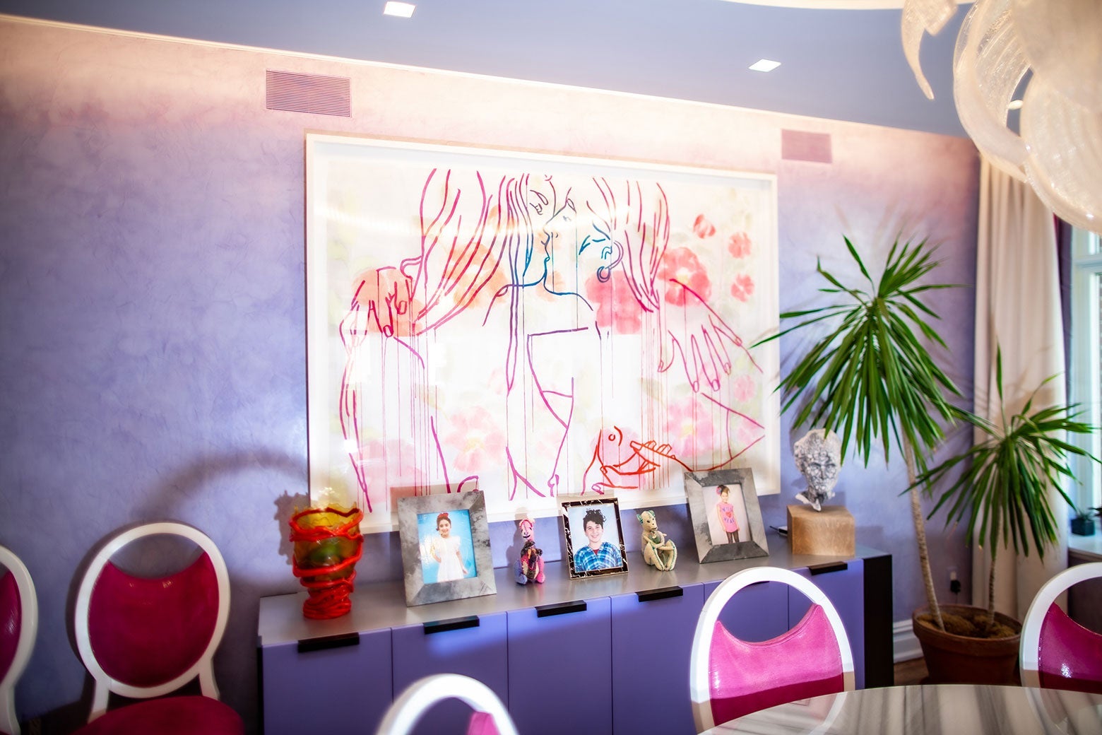 A piece of artwork in Rubenstein’s home hangs over a purple credenza.