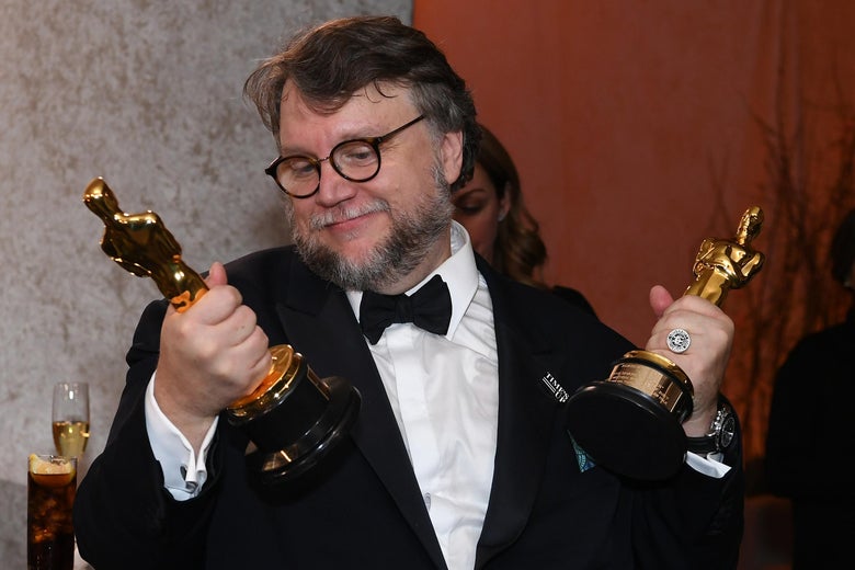 Guillermo del Toro, with an Oscar statuette in each fist.