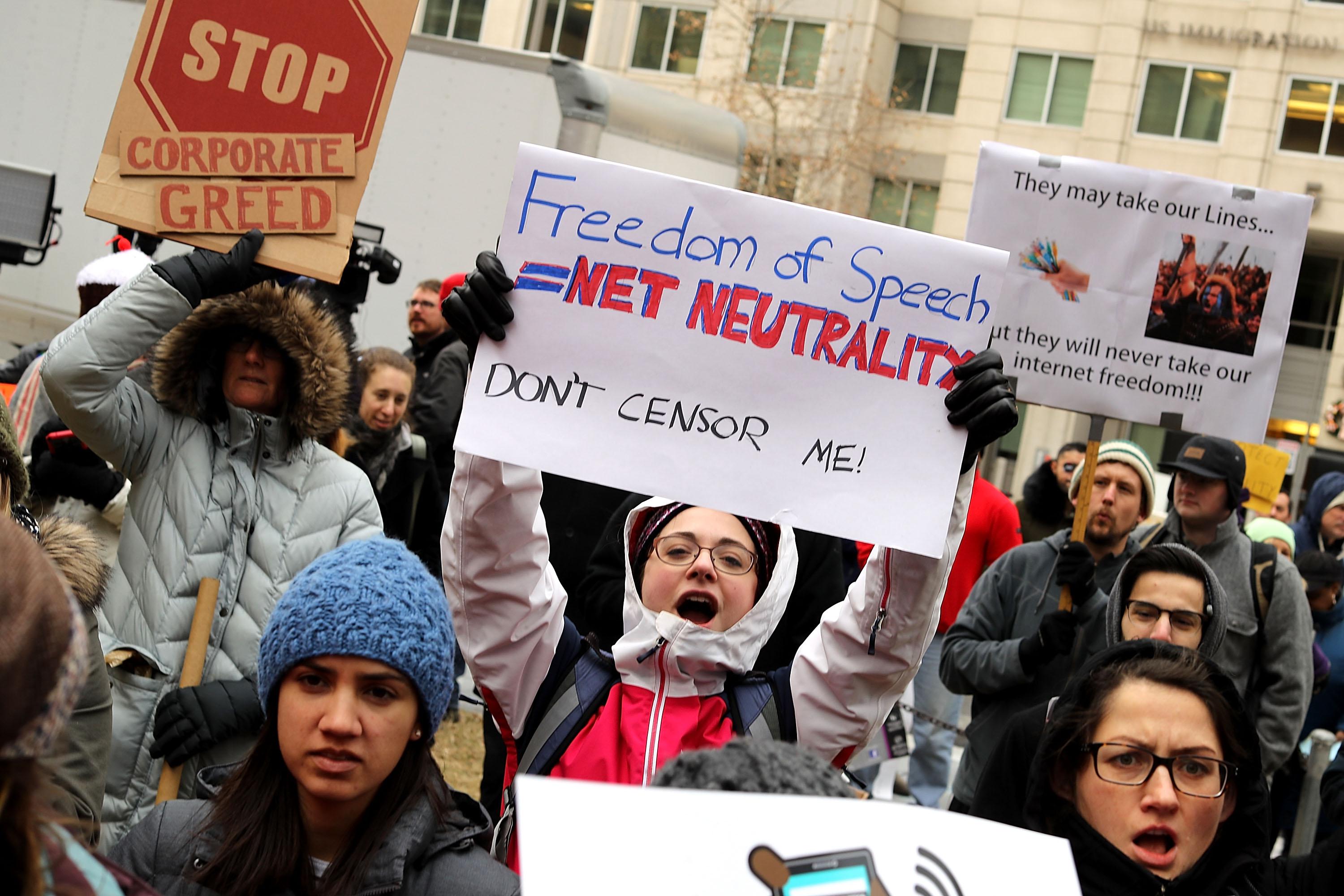 Demonstrators rally outside the Federal Communication Commission building to protest against the end of net neutralityrules December 14, 2017 in Washington, D.C. 
