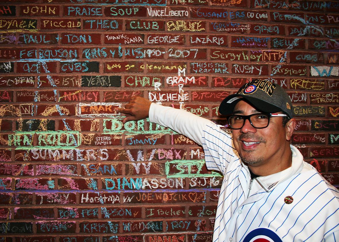 Chicago Cubs fans hold up a sign after game 7 of the World Series  suggesting that their was DIVINE influence