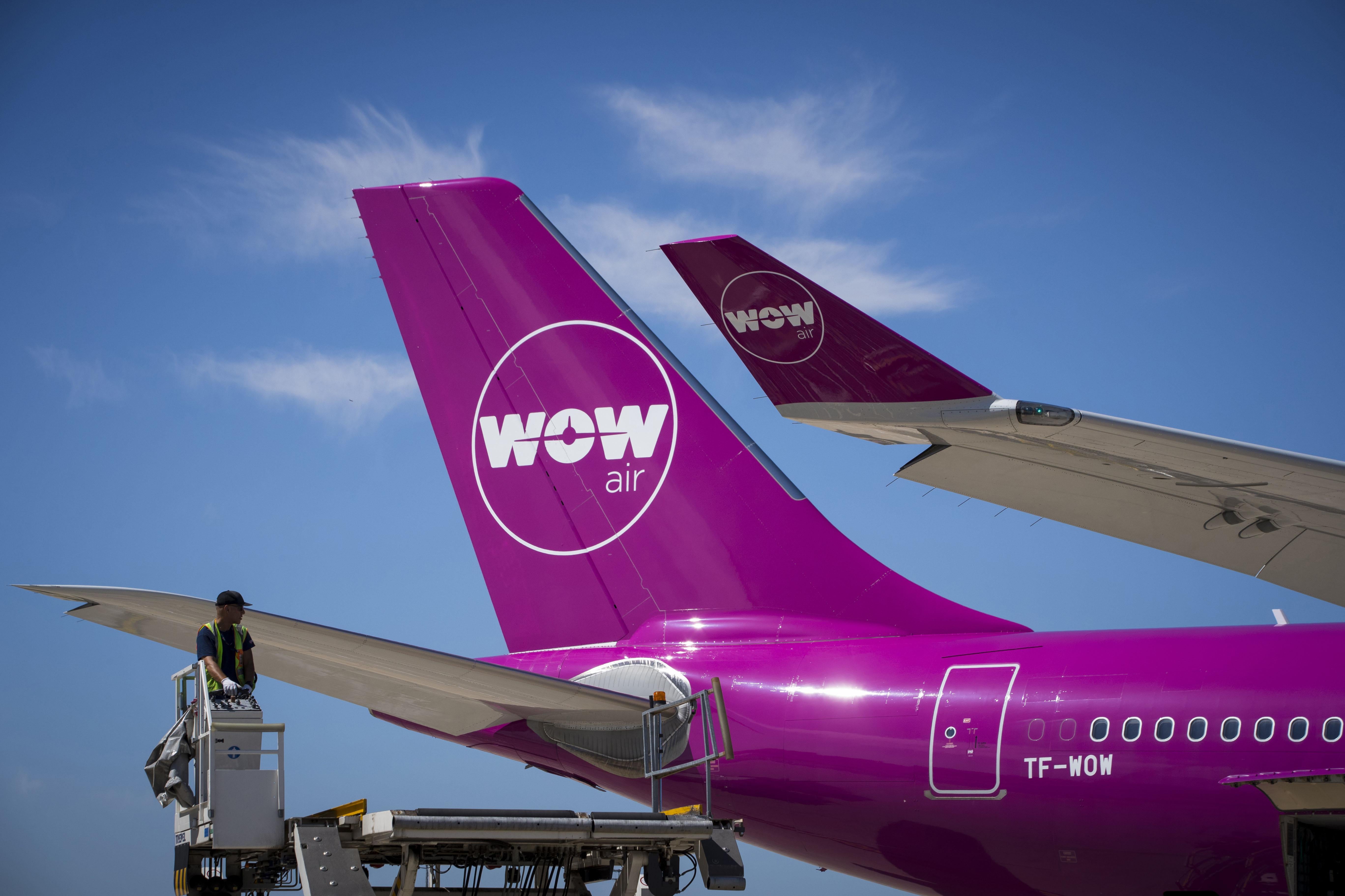 A bright pink Wow plane on the tarmac.