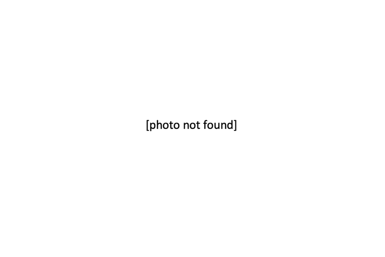 In the middle of blank, white space, black text in brackets reads: "photo not found."