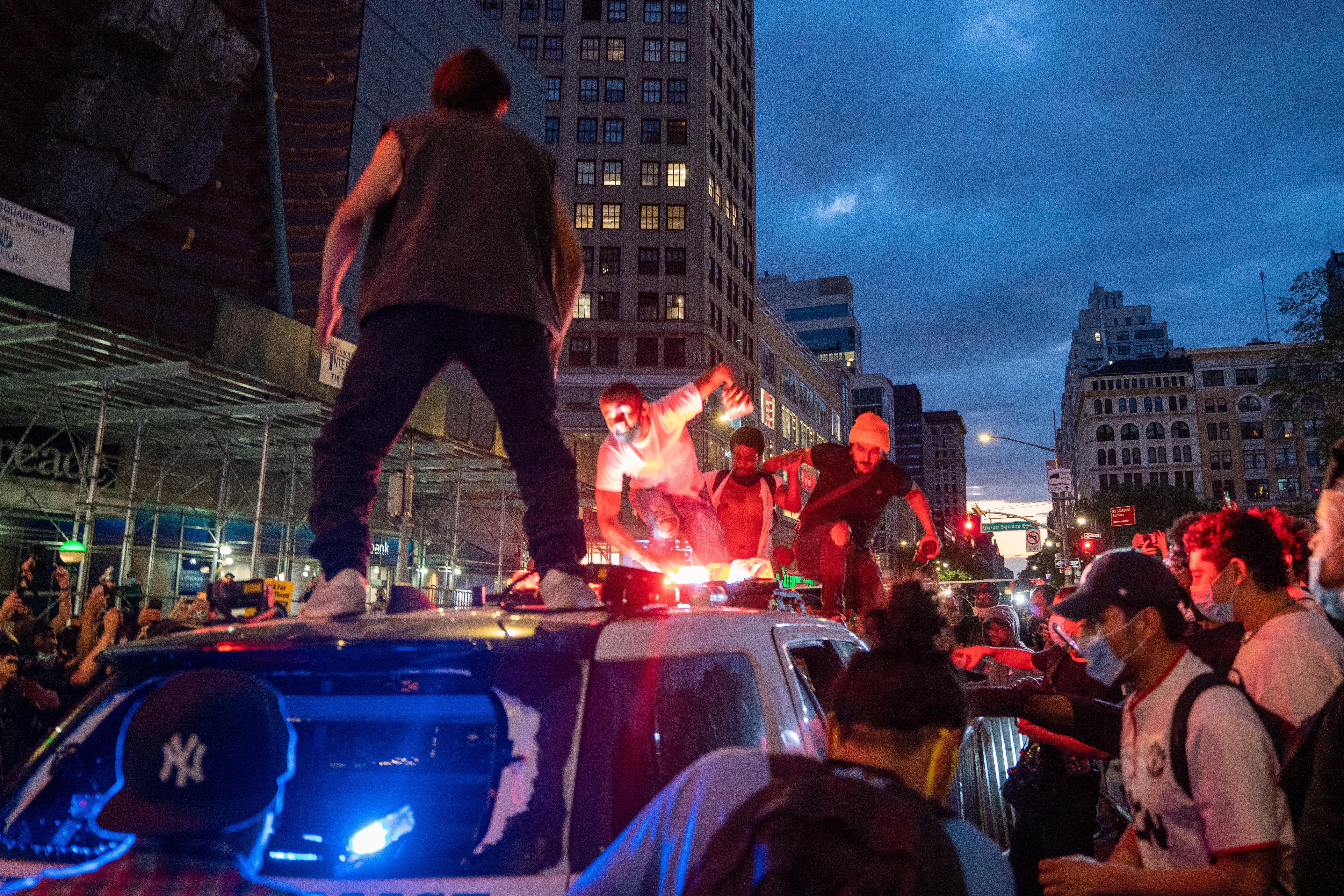 Protesters vandalize a police cruiser in Union Square on May 30, 2020 in New York City.
