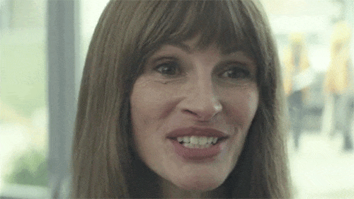 Julia Roberts as Heidi, grinning in a fake, creepy way.