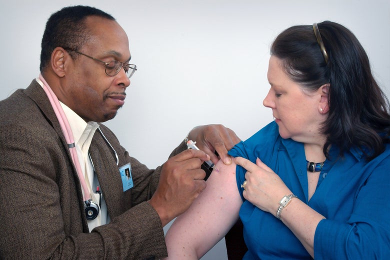 A man injects a woman's arm.