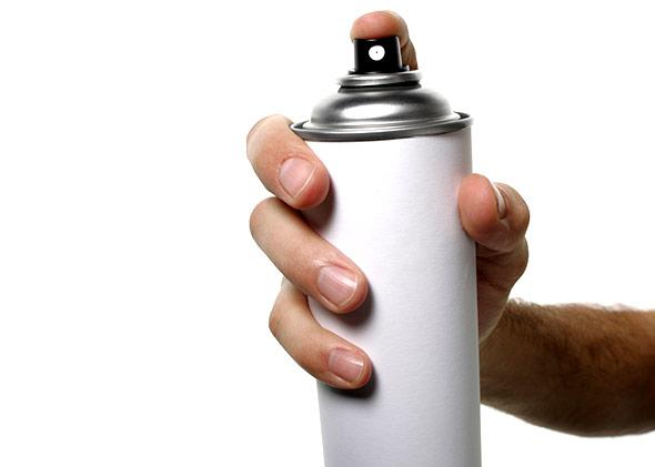An aerosol spray can.